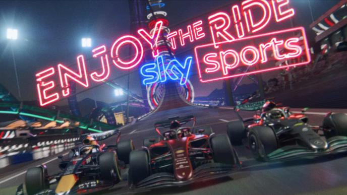 Three F1 cars on a track, in the background "enjoy the ride, sky sports" in neon lettering