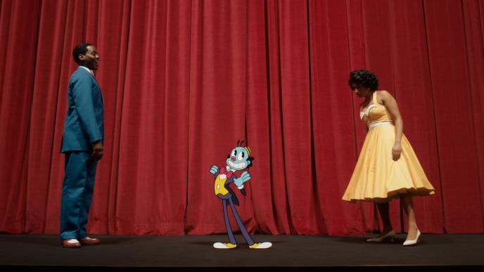 The Doctor and Belinda looking at a 2D animated Mr Ring a Ding on a stage. 