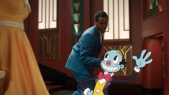 The Doctor circling a 2D animated Mr Ring a Ding on a stage. 