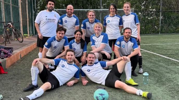 The Framestore soccer team from Montreal posing as a team in white and blue sports kits. 