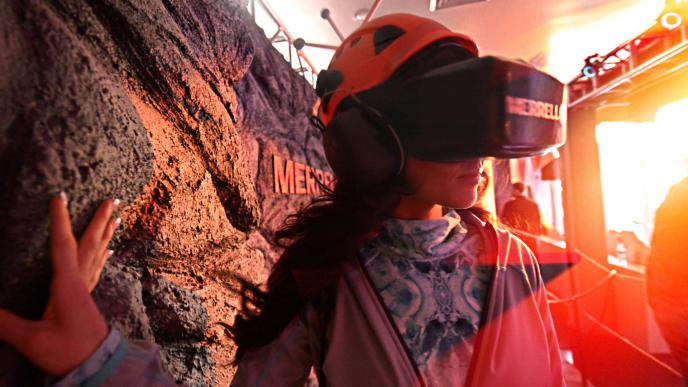 a woman wearing a vr headset walking through a trail