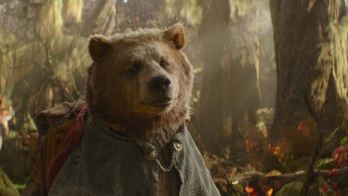 Dulcie Bear in Wicked: For Good, a CGI animated bear in a forest wearing a coat