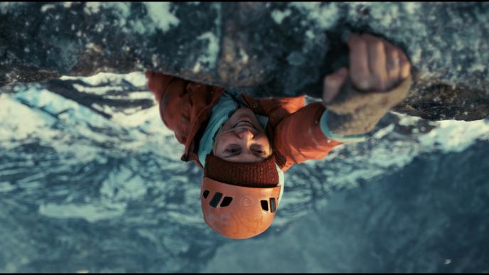Sasha, played by Charlize Theron, climbing the Troll Wall