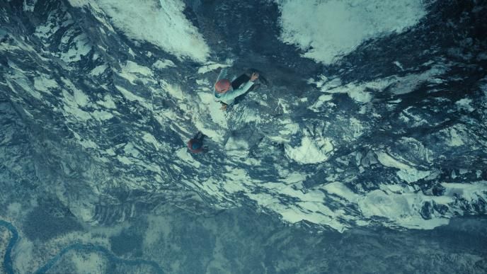 Sasha, played by Charlize Theron, and Tommy, played by Eric Bana, climbing Norway's Troll Wall with final VFX from Framestore