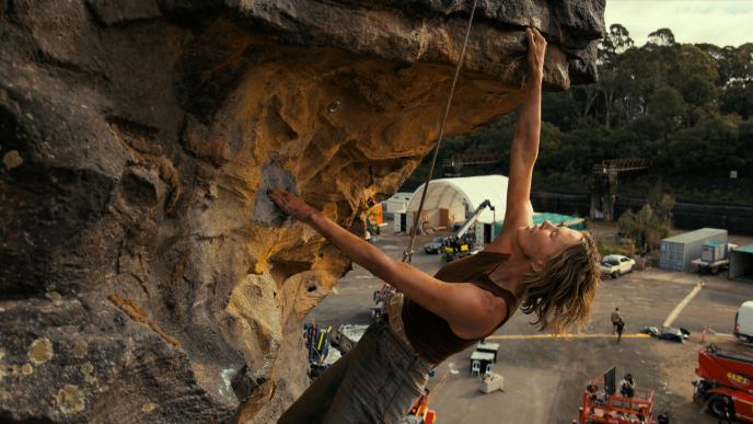Plate photography of Charlize Theron climbing the Australian gorge set
