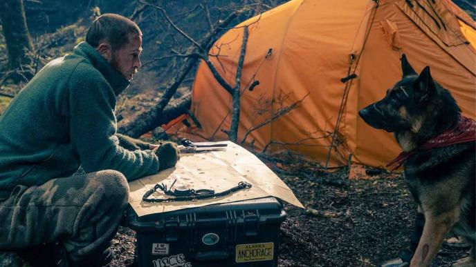 Heart of the Beast film still featuring Brad Pitt and dog companion in wilderness