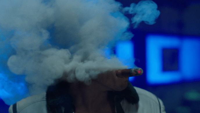 thick smoke that obscures their face, with a glowing cigarette and blue-lit background.