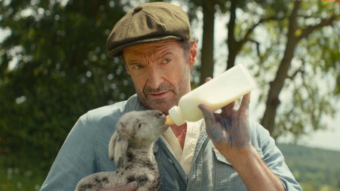 Hugh Jackman bottle feeds a CGI lamb in The Sheep Detectives