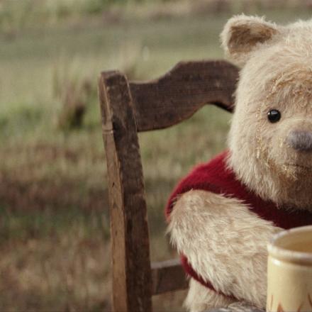 cg animated photorealistic winnie the pooh bear sitting at a table in front of honey jars