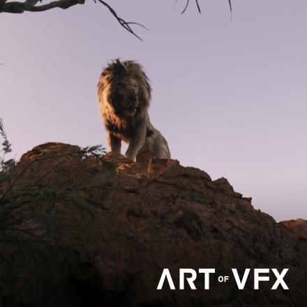 A lion sits on top of a large rock