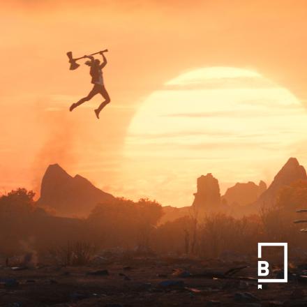 Thor jumps with his hammer, in front of a sunset, with a small white logo in the bottom right corner