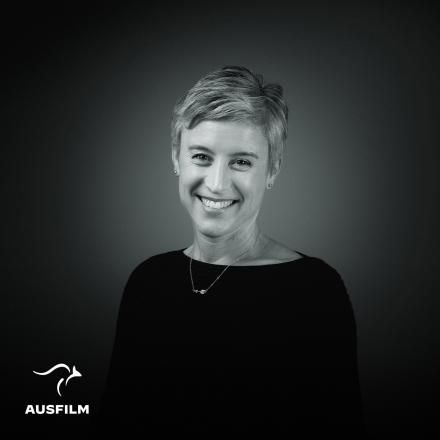 A photograph of Lara Hopkins in black and white against a black background, there is the AusFilm logo in the bottom left corner.