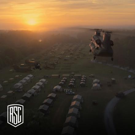 A helicopter flying over a military encampment of tents towards a sunset, with the American Cinematographer in the bottom right corner.