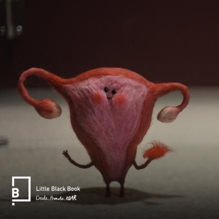 A small VFX felted uterus and ovaries with eyes and a face waving water the viewer, there is the LBB logo in the bottom left corner.