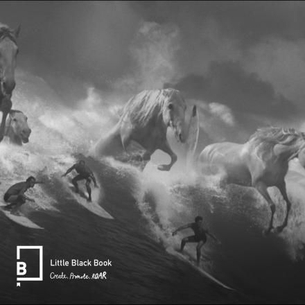 A black and white image showing CG horses coming out a wave among a group of surfers.