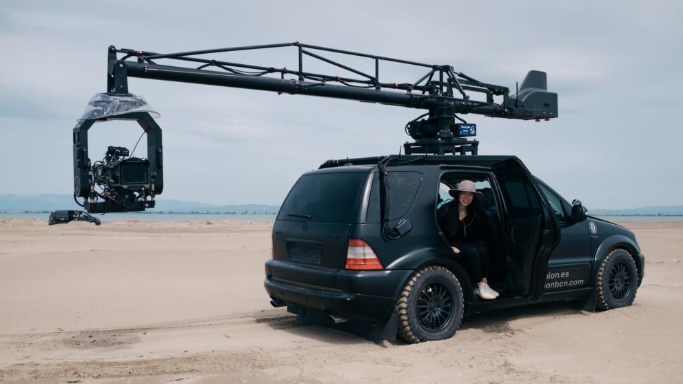 Anh Vu on set, inside a large car with a camera rig