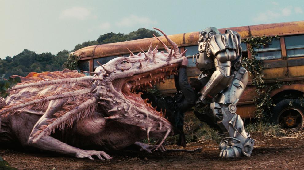 A large pink amphibious creature swallowing a solider who is being pulled out by a large robotic armoured man. 