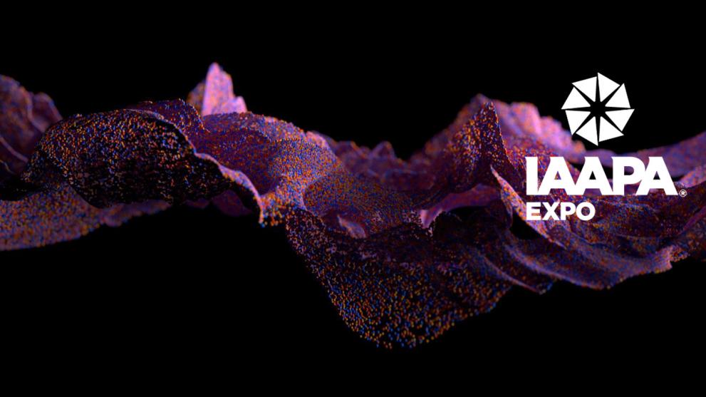 A black background with a pink CGI fluid shape across the middle and a white IAAPA logo to the right hand side.