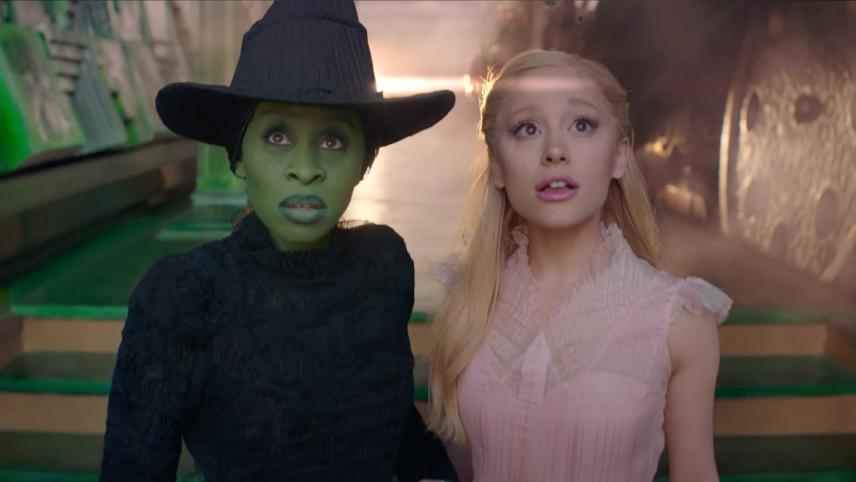 Elphaba and Glinda look upwards, towards the sky